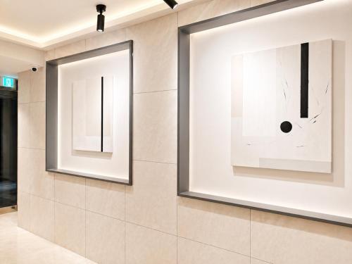 a room with two large windows on the wall at Busan Station Iruda Hotel in Busan