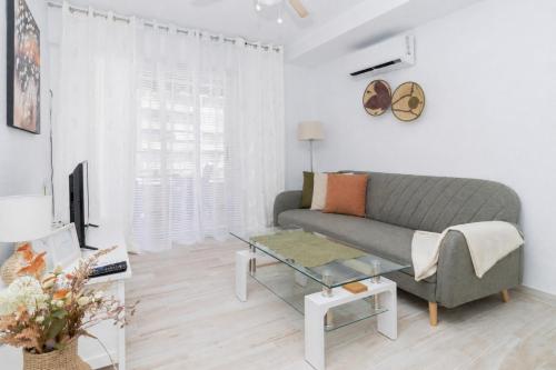 a living room with a couch and a glass table at Harmonia in Punta Prima