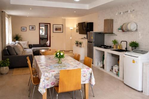 a kitchen and living room with a table and chairs at vitamin sea villas in Ko Chang