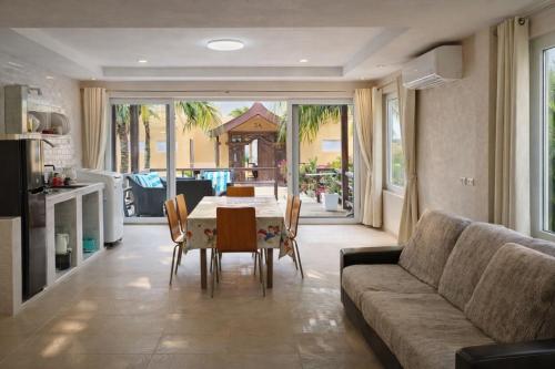 a living room with a table and a couch at vitamin sea villas in Ko Chang