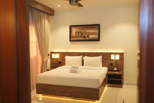 a bedroom with a bed with a teddy bear on it at Sunset BnB Ramna Islamabad in Islamabad