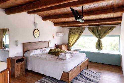 a bedroom with a bed and a large window at Paradise House in Maratea