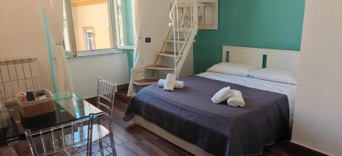 a bedroom with a bed with two towels on it at Appartamenti Mergellina in Naples