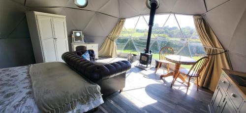 a room with a bed and a table in a tent at alpaca view Dome in New Holland
