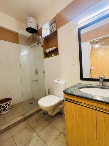 a bathroom with a toilet and a sink and a mirror at Golden Pent House in Lucknow