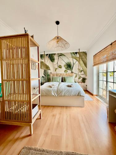 a bedroom with a bed and a book shelf at Casa Sol e Sal in Luz