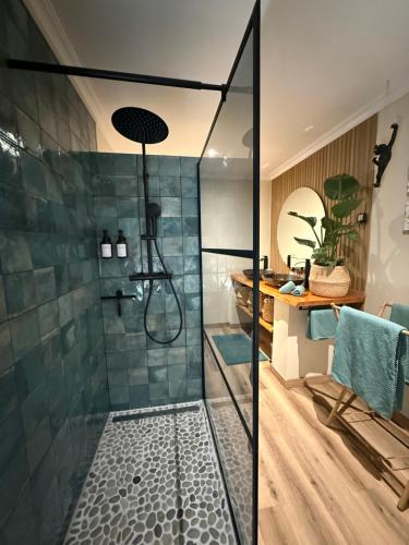 a bathroom with a shower with a glass door at Casa Sol e Sal in Luz
