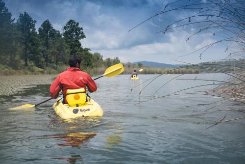 a man in a kayak on a body of water at Hotel La Casona in Tapalpa