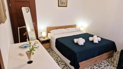a bedroom with a bed with two pillows on it at Calle Bottari ChioggiaPL in Chioggia