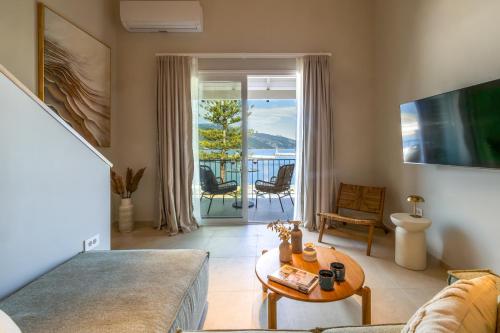 a living room with a couch and a table at Cavaliere Seafront House - Thalia in Sami