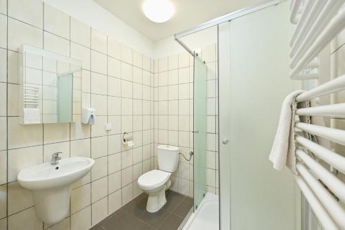 a bathroom with a toilet and a sink and a shower at Marina Grudziądz in Grudziądz