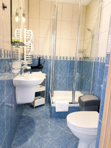 a bathroom with a sink and a toilet and a shower at Willa Park in Zakopane