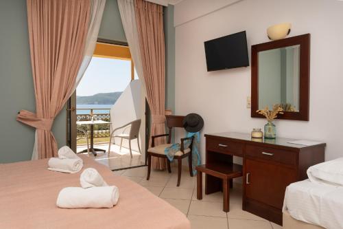 a hotel room with two beds and a mirror at Finiki Plaza in Methoni