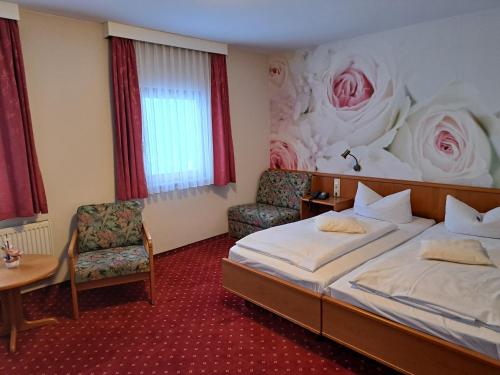 a hotel room with a bed and a flower wall at Naturhotel Lindenhof in Rechenberg-Bienenmühle