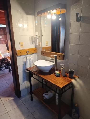 a bathroom with a sink and a mirror at La Serena casa de campo y senderismo in Villa Serrana