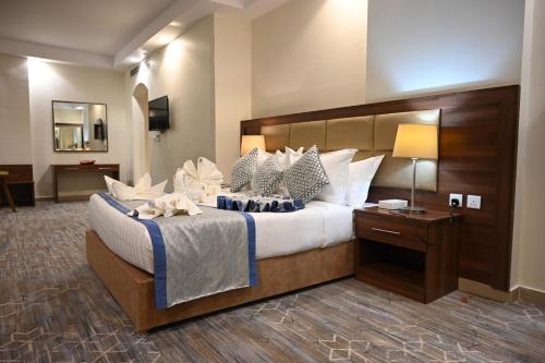 a bedroom with a large bed with a large headboard at فندق دوما - Domma hotel in Medina