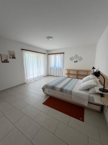 a bedroom with a large bed and a tiled floor at Appartamento sole in Isone