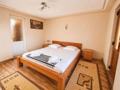 a bedroom with a bed with two towels on it at Casa Marinca in Ocna Şugatag