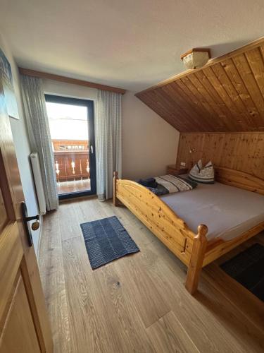 a bedroom with a large bed with a wooden ceiling at Haus Mariandl in Westendorf