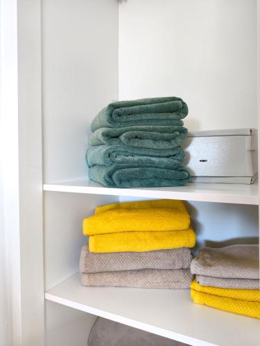a stack of towels on a shelf in a closet at Incredible Sunsets in Puerto Rico de Gran Canaria