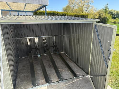 a metal shed with a solar roof on it at Gästezimmer Mia in Donauwörth