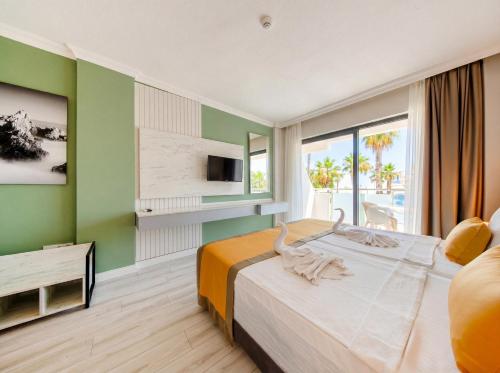 ein Hotelzimmer mit Bett und Fernseher in der Unterkunft Tropic Beach Resort Hotel in Side
