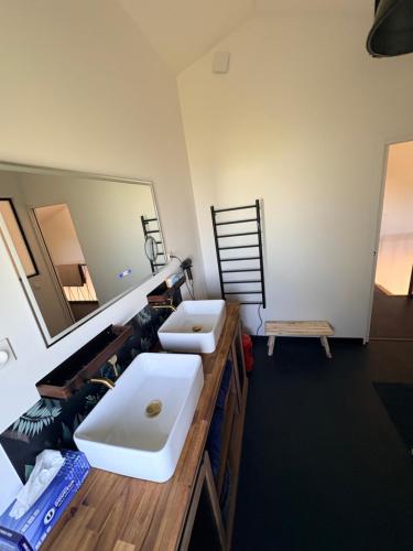 a bathroom with a white sink and a mirror at L Amy-Côtier in Saint-Pierre-dʼOléron