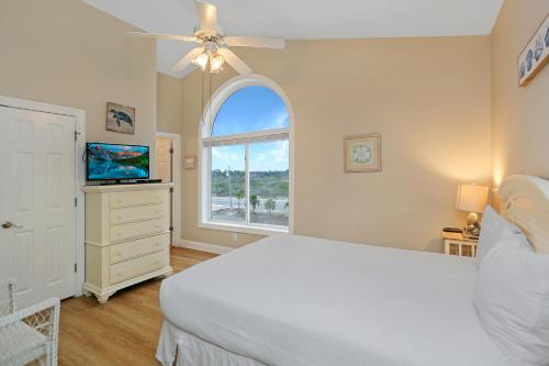 a white bedroom with a bed and a window at Beach Blessing by Pristine Property Vacation Rentals in Cape San Blas