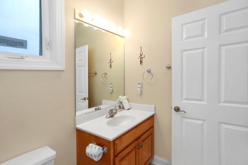 a bathroom with a sink and a mirror at Beach Blessing by Pristine Property Vacation Rentals in Cape San Blas
