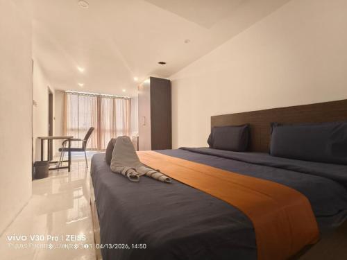 a bedroom with a large bed and a table at Apex Inn Gulf View in Bangalore