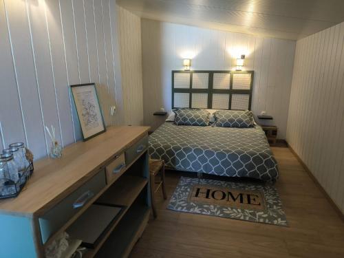 a small bedroom with a bed and a dresser at Studio 80m2 a la ferme tout confort in Courdemanche