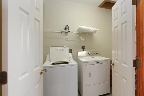 a small white laundry room with a washer and dryer at Hatchling Hideaway by Pristine Property Vacation Rentals in Indian Pass