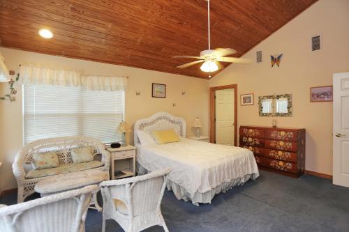 a bedroom with a bed and a ceiling fan at Hatchling Hideaway by Pristine Property Vacation Rentals in Indian Pass