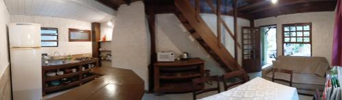 a small kitchen with a counter and a sink in a room at Apartamentos do Centrinho do Rosa in Imbituba