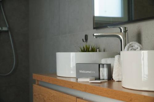 a bathroom counter with two white towels and a sink at Villa Tomaté in Velika Buna