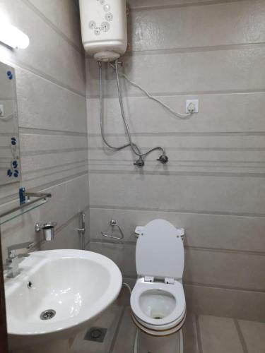 a bathroom with a white toilet and a sink at Hotel Best Ocean in Kathmandu