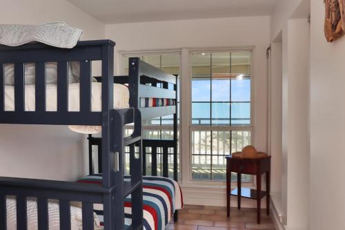 a bedroom with two bunk beds and a window at White Pelican by Pristine Property Vacation Rentals in Indian Pass