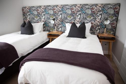 two twin beds in a room with two side tables at PenthouseOne on the Canals in Marina Glades