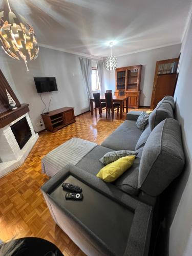 a living room with a gray couch with yellow pillows at Stay & Smile Apartment in Póvoa de Varzim