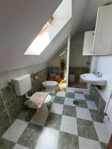 a bathroom with a toilet and a sink at Guest House Plitvice Waterfall in Plitvička Jezera