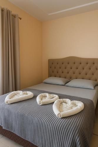 a bedroom with two pillows on a bed at Pousada Recanto dos Pássaros in Linhares