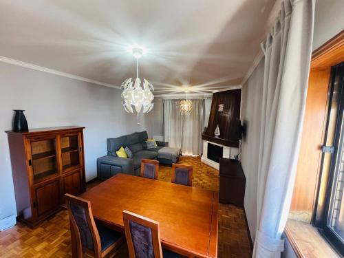 a living room with a table and a couch at Stay & Smile Apartment in Póvoa de Varzim