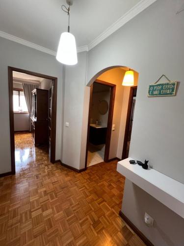 a living room with a hallway with a hard wood floor at Stay & Smile Apartment in Póvoa de Varzim