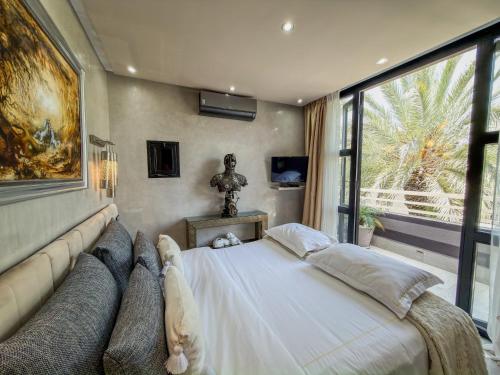 a bedroom with a bed and a large window at Villa Mano in Marrakesh