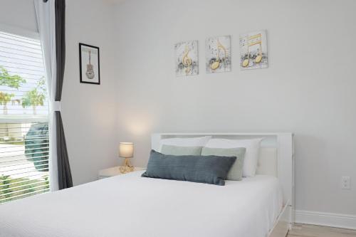 a white bedroom with a white bed and a window at Backwater Bliss by Pristine Properties Vacation Rentals in Saint Joe Beach