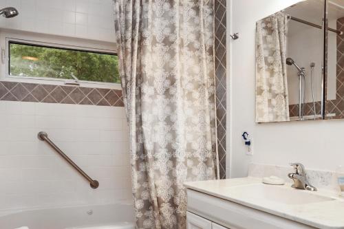 a bathroom with a shower curtain and a sink at Wales Pod by Pristine Properties Vacation Rentals in Indian Pass