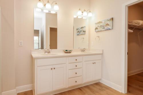 a bathroom with two sinks and a large mirror at WindMark Beach North by Pristine Properties Vacation Rentals in Saint Joe Beach