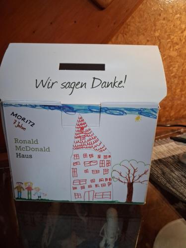 a box with a drawing of a house on it at Haus Seemöwe Obergeschoss in Wittmund