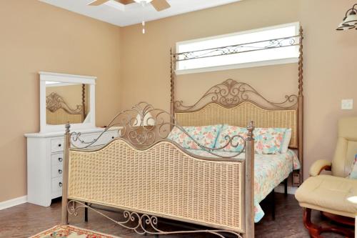 a bedroom with a canopy bed and a mirror at Dolphin Daze by Pristine Properties Vacation Rentals in Saint Joe Beach