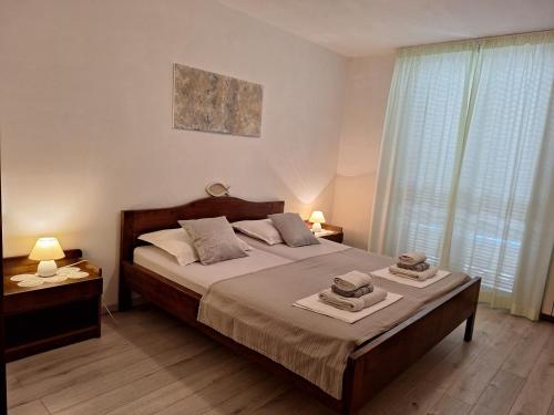 a bedroom with a bed with two hats on it at Apartments and Rooms Vinko in Barbat na Rabu